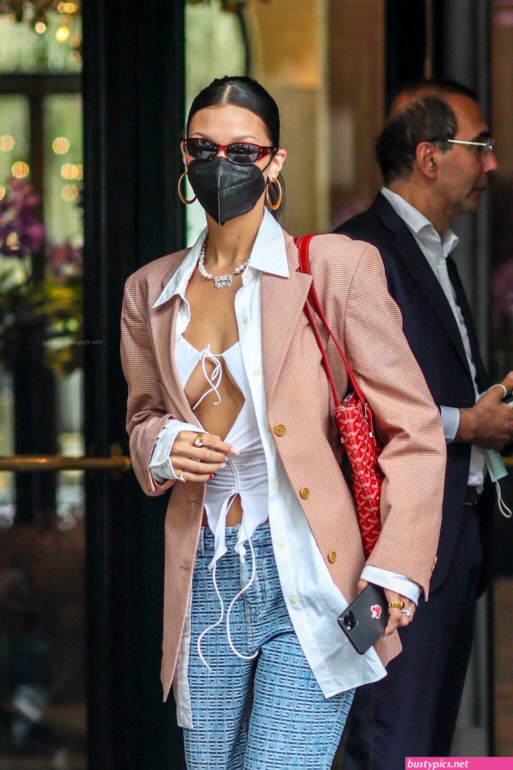 braless bella hadid steps out of the george v hotel with a friend
