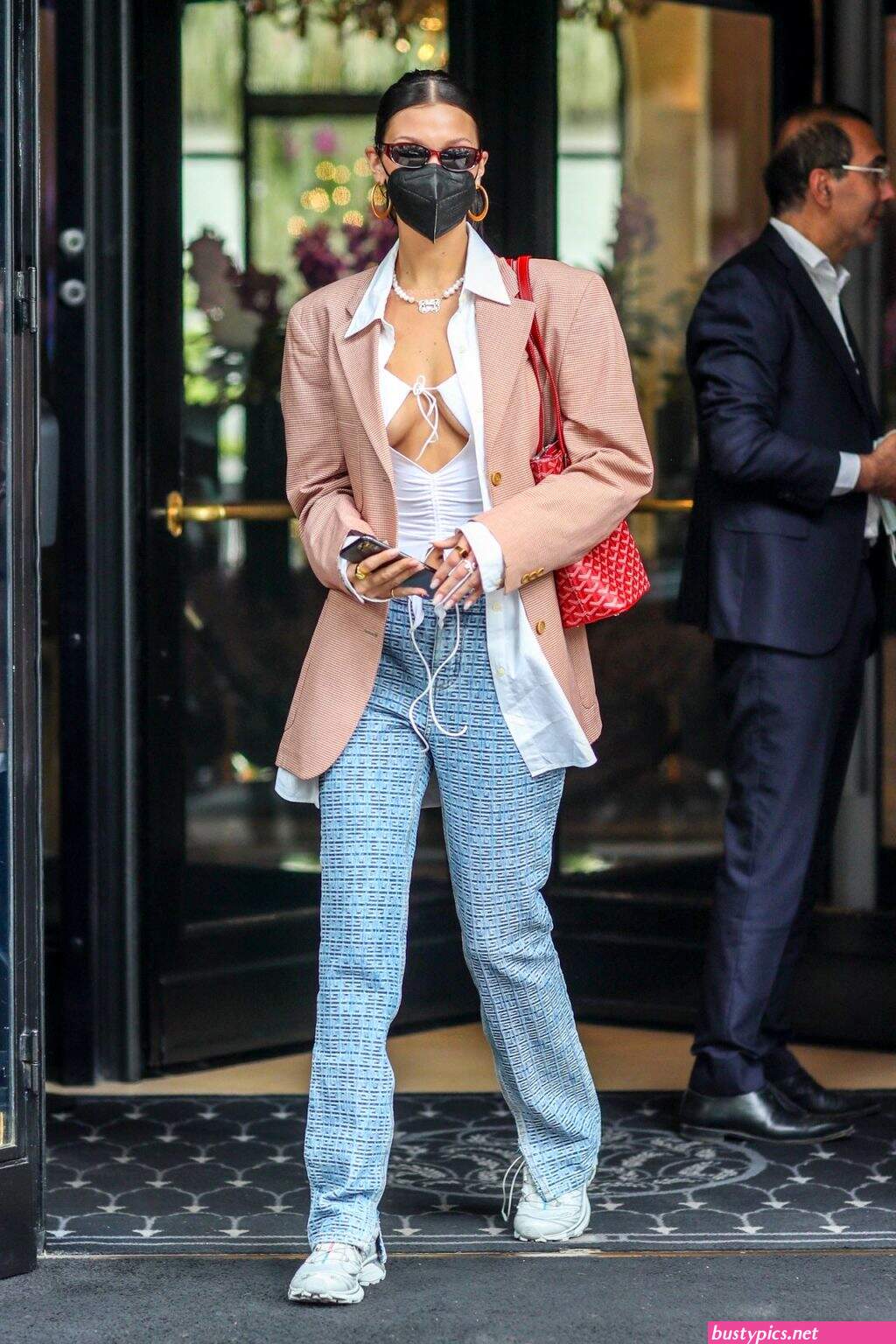 braless bella hadid steps out of the george v hotel with a friend