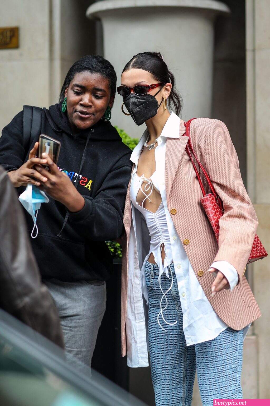 braless bella hadid steps out of the george v hotel with a friend