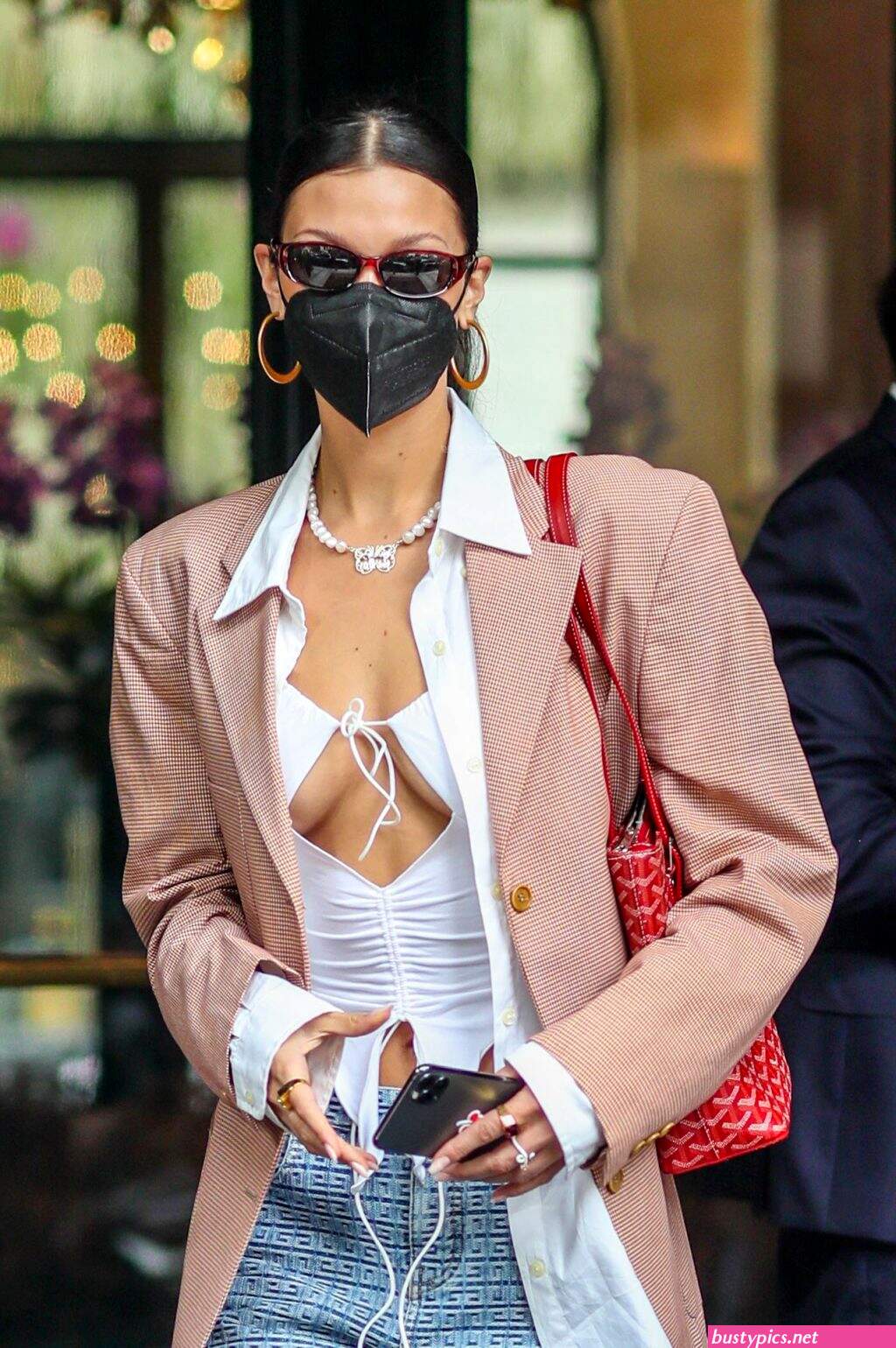 braless bella hadid steps out of the george v hotel with a friend