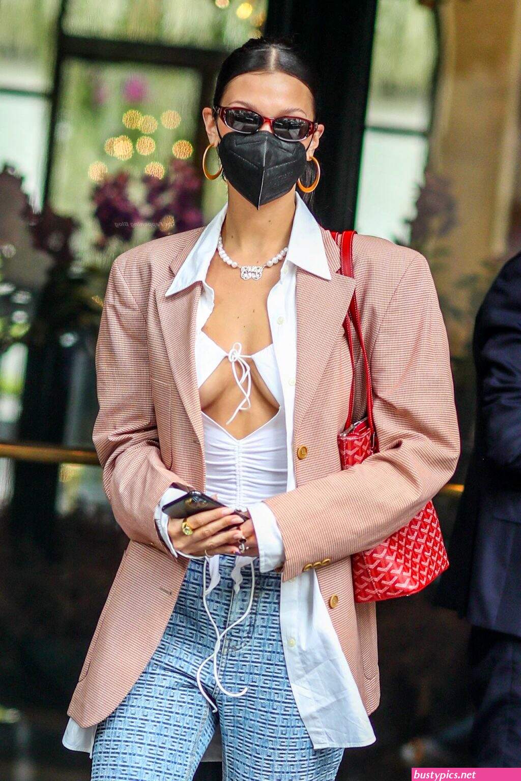 braless bella hadid steps out of the george v hotel with a friend
