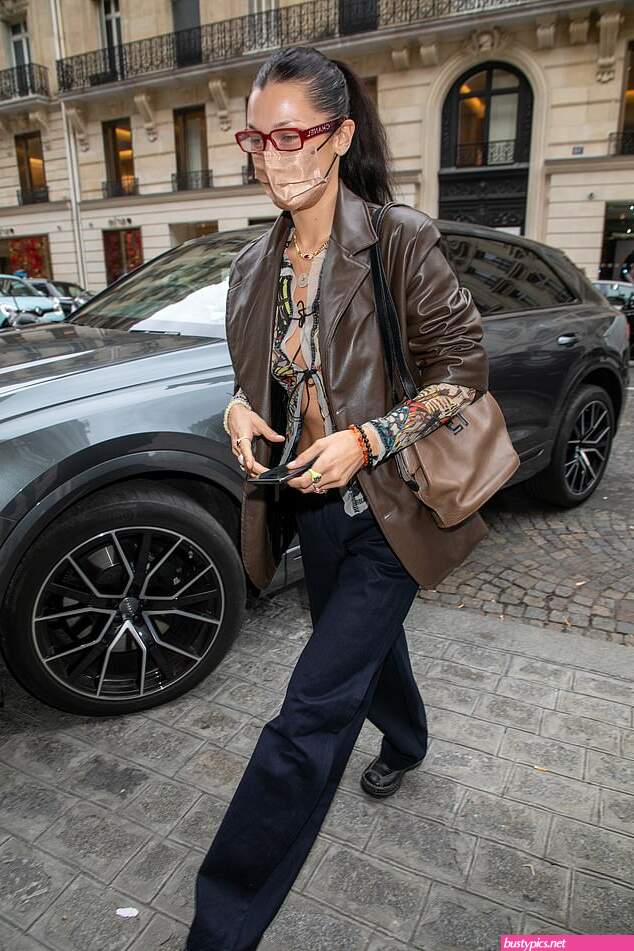 braless bella hadid steps out of the george v hotel with a friend