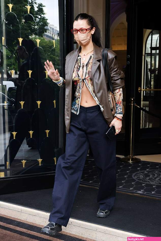 braless bella hadid steps out of the george v hotel with a friend