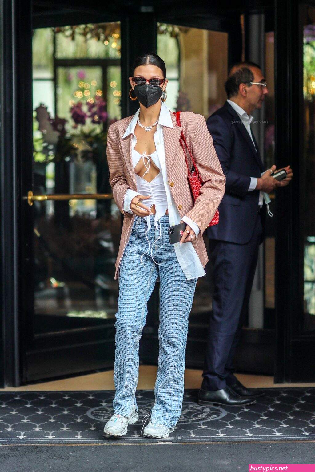 braless bella hadid steps out of the george v hotel with a friend