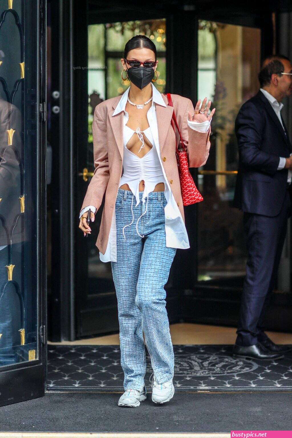 braless bella hadid steps out of the george v hotel with a friend