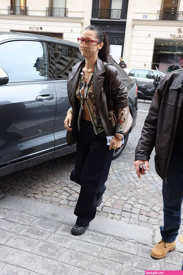 braless bella hadid steps out of the george v hotel with a friend