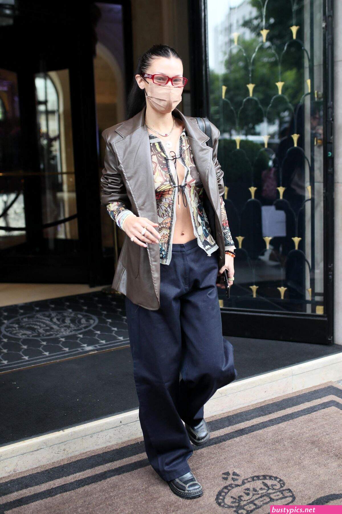 braless bella hadid steps out of the george v hotel with a friend